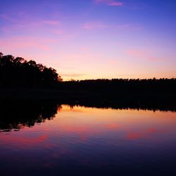 Scenic view of lake against romantic sky at sunset