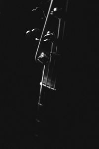 Close-up of guitar against black background