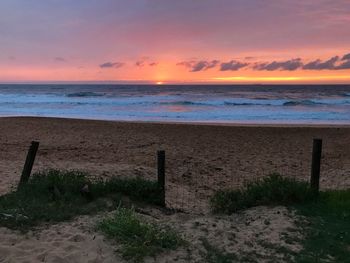 Scenic view of beach against sky during sunset