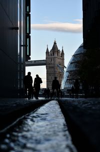 Silhouette of people walking in city