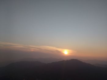 Scenic view of silhouette mountains against sky at sunset