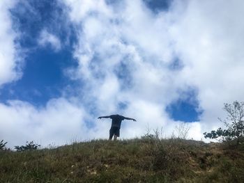 Low angle view of bird flying over land