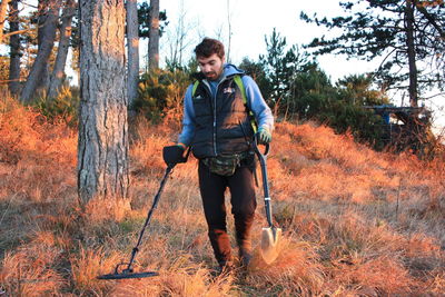 Full length of man standing in forest