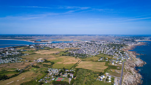 High angle view of trees by sea against blue sky