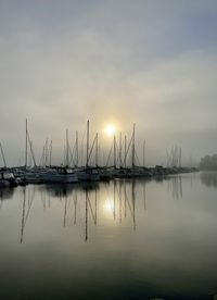 Sailboats in lake at sunset