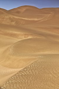 0244 chains of moving sand dunes cover the surface of the taklamakan desert. yutian-xinjiang -china.