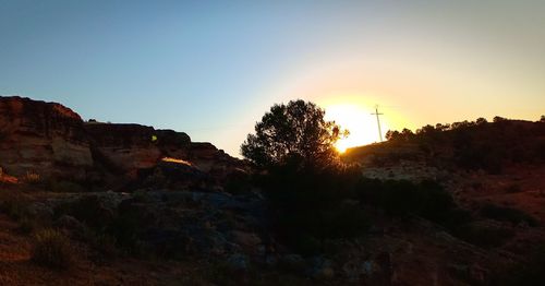 Scenic view of mountains against clear sky during sunset