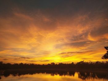 Scenic view of lake against romantic sky at sunset