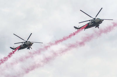 Low angle view of airshow against sky