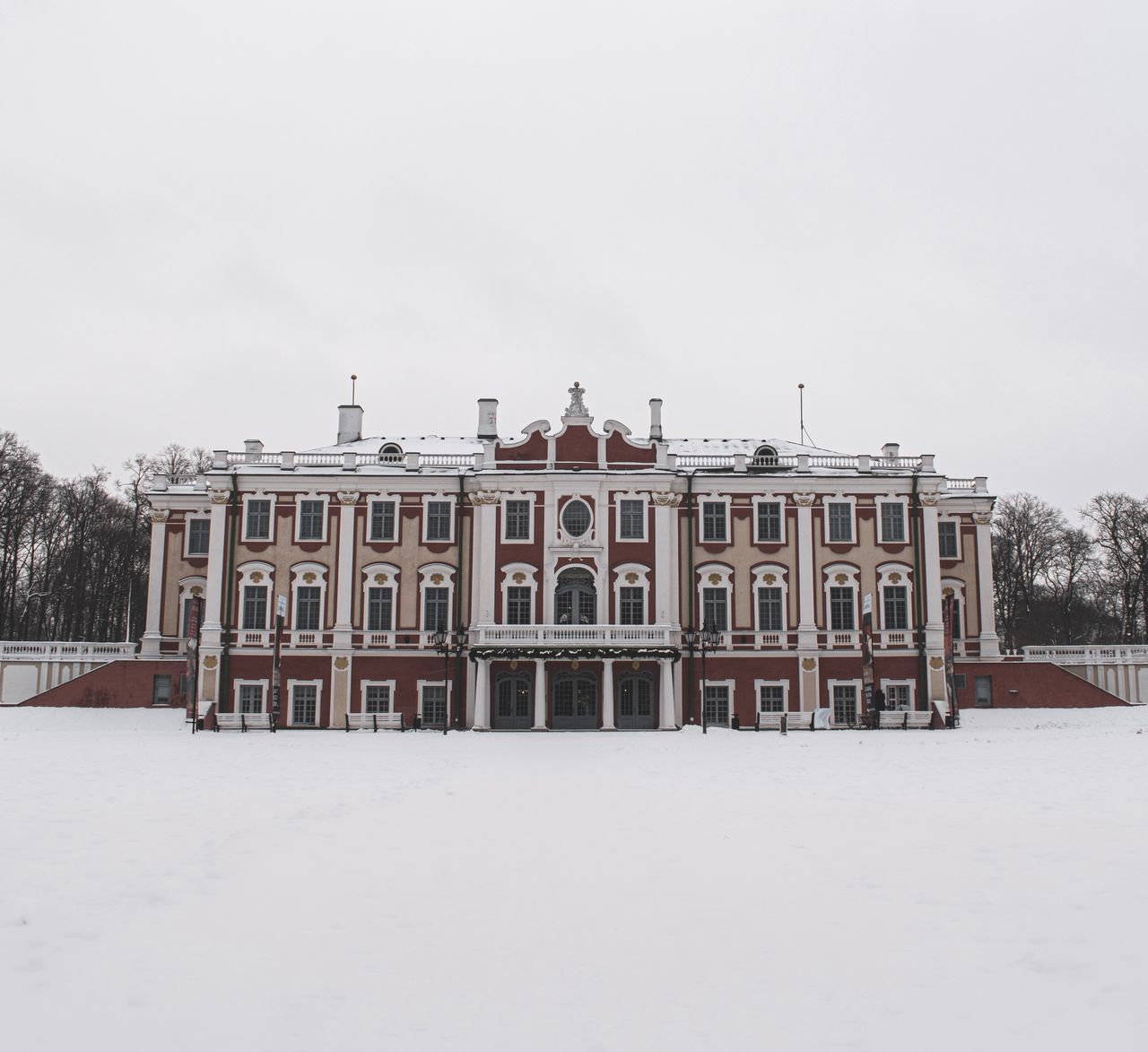 BUILDING ON SNOW COVERED FIELD AGAINST SKY