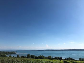 Scenic view of sea against blue sky