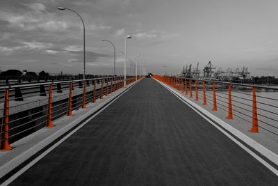 Street lights on bridge against sky