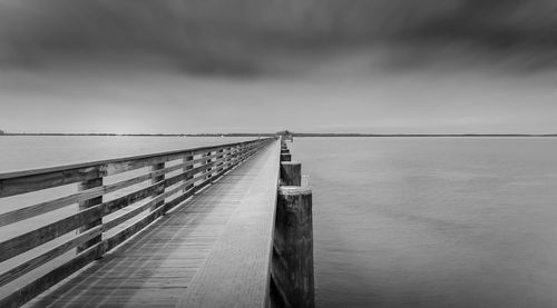 Pier over sea against sky