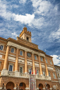 Low angle view of building against cloudy sky