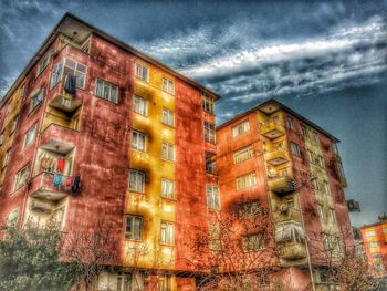 Low angle view of building against cloudy sky