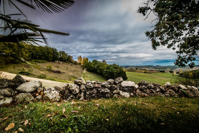 Scenic view of rocks on landscape against sky