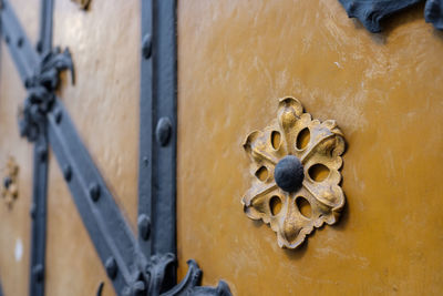 Ornaments and gilding at a old door with wrought rin with blurred unscharpness