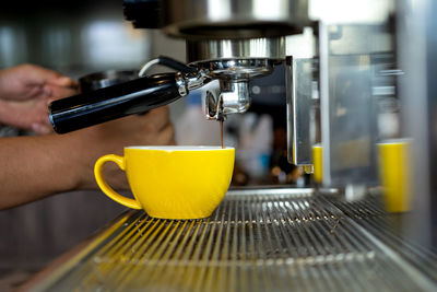 Man pouring coffee in cup