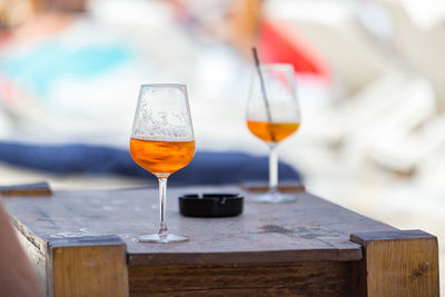 Close-up of beer on table at beach
