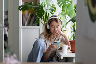 Woman listening music while sitting at home