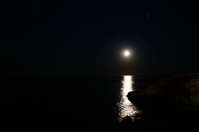 Scenic view of sea against clear sky at night