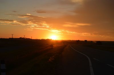 Sun shining through clouds over landscape