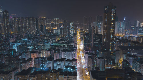 Illuminated cityscape against sky at night