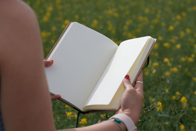 Midsection of woman using digital tablet