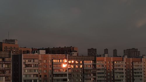 Buildings in city against sky at night