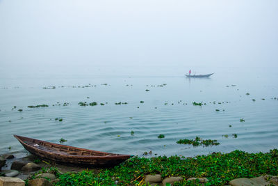 The winter morning in the riverbank with traditional boat. 