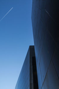 Low angle view of modern building against clear blue sky