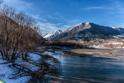 Scenic view of snowcapped mountains against sky during winter