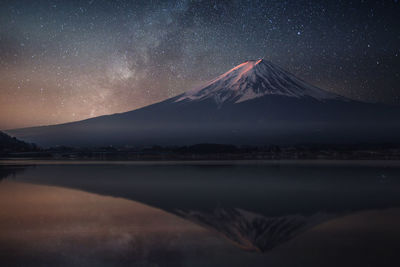 Scenic view of majestic mountains against sky at night