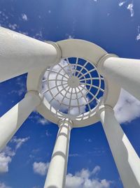 Low angle view of cross tower against sky