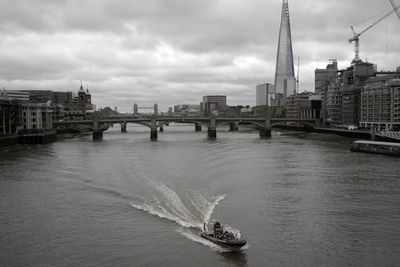 Bridge over river with buildings in background