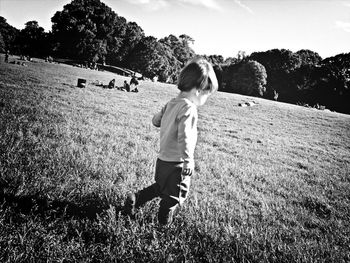 Boy playing on grassy field