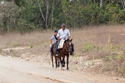 Men riding horse