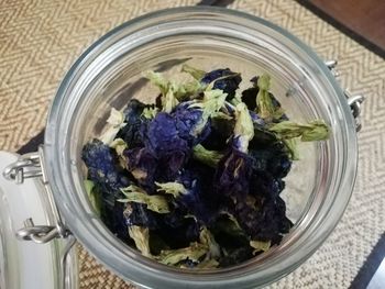 High angle view of bouquet in glass container on table