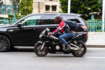 Man riding motorcycle on road