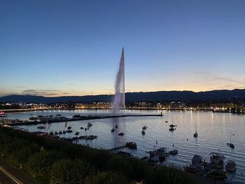 Sailboats in lake against sky during sunset