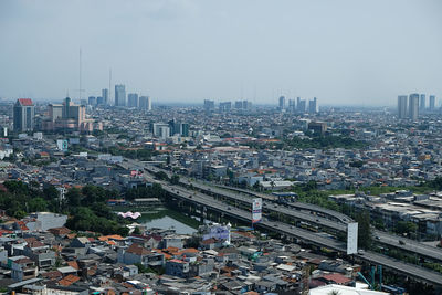 High angle view of illuminated city buildings against sky