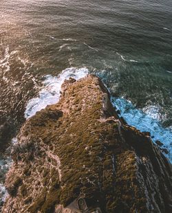 High angle view of cliff by sea