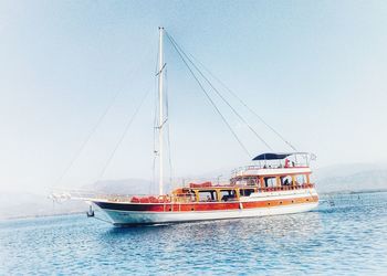 Ship sailing on sea against clear sky