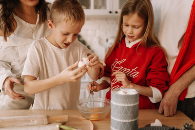 Family with children having fun and laughing while preparing for the christmas holiday in kitchen