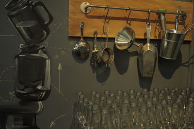 Close-up of glass bottles against kitchen utensils