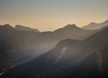 Scenic view of mountains against clear sky during sunset