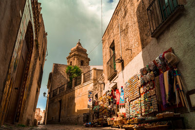 A tourist stand in an empty alley in the historic town of erice in sicily, italy.