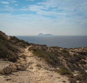 Scenic view of sea and mountains against sky