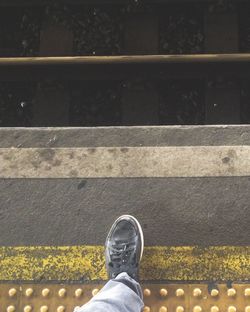 Low section of person standing on street