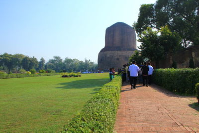 Rear view of people walking on footpath